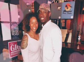A couple poses for a photo in a parlor