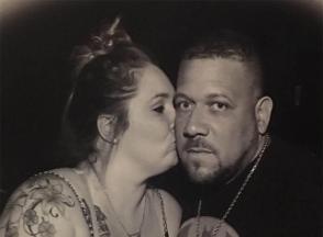 A woman kisses her partner