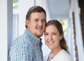 A couple poses for a photograph.