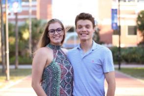 A couple poses for an outdoor photo.